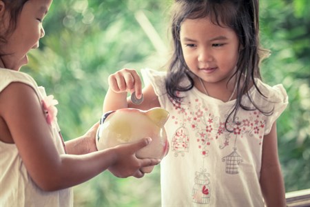 Girl With Piggy Bank Adams Istock