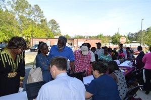 Photo from last year's community event with Rep Anderson - image of constituents lined up to check to see if they have unclaimed property