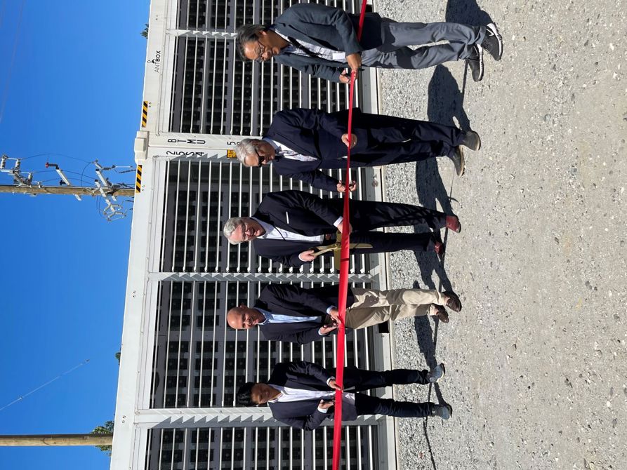 Officials participate in a ribbon-cutting ceremony for BV Power Alpha, LLC