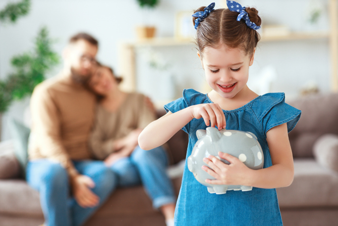 Young girl saving money with family